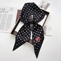 Elegant black silk scarf with white polka dots and pink floral prints in a bow shape - Black