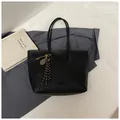Detail van de zwarte tote bag van generfd leer met gouden bedels en kwastjes - Met Hanger / Zwart