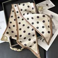 Elegant beige silk scarf with black polka dots and brown borders on a vintage tray - Khaki