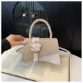 Sac bandoulière chic beige et or avec boucle florale en métal et design patchwork - Or