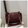 Close-up of wine red faux snakeskin texture and gold chain strap on the flap bag - Burgundy