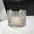 Chic houndstooth tote bag with beige leather straps and a cute cat-shaped charm - White