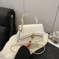 Chic white faux leather crossbody bag with gold twist lock and elegant top handle - White