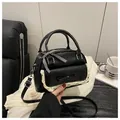 Black faux leather handbag with white lace trim, bow detail, and adjustable strap - Black