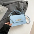 Chic light blue crossbody box bag with metallic lock closure and single handle - Blue