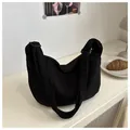 Detail showing the ribbed corduroy texture and adjustable strap of the black hobo bag - Black