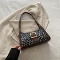 Schicke Handtasche mit Leopardenmuster, goldener Schnalle und braunem Lederbesatz - Schwarz