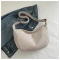 Minimalist beige corduroy half-moon crossbody bag with adjustable strap on denim jacket - Off White