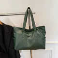 Détail d'un grand cabas vert foncé avec large bandoulière et poche latérale pratique - Vert