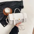Elegant beige crossbody handbag with woven texture flap and gold hardware details - White