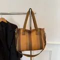 Vertical striped canvas tote bag in earthy tones with wide handles and shoulder strap - Yellow