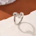 Adjustable silver crossover ring with pavé zircons and a large single claw-set solitaire stone - Letter Q Style