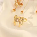 Detail of 18K gold plated geometric ring with emerald cut zircon and open band design - Geometric Long Bar Open Style (Style A)