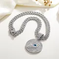 Close-up of hip-hop cuban chain with Horus Eye pendant encrusted with white and blue stones - Pendant + Cuban Chain / Silver