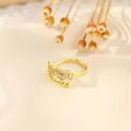 Close-up of a vintage 18K gold plated copper ring with zircon stones and golden beads - Vintage Floral Cluster Half Crown (Style M)