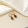 Detail of gold hoop earrings featuring teardrop brown tiger eye stones on silk - Dark Brown