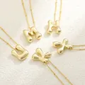 Detailed view of 18K gold plated puffy letter pendants M H U K X with mirror finish - Gold Bead Chain