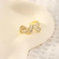 Elegant 18K gold plated bow ear cuff with baguette zircons on a realistic ear model - Bow Ear Cuff Style (Style B)