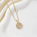 Macro detail of gold-plated pendant with letter F and radiating zircon stones - Letter F