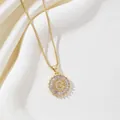 Macro detail of gold-plated pendant with letter G and baguette crystal surround - Letter G