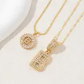 Detailed close-up of gold plated letter B pendants with sparkling zircon stones on stone - Gold - Letter B