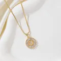 Detailed macro view of gold-plated pendant with letter X and sparkling zircon inlay - Letter X