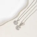 Silver tone letter C pendant necklace with sparkling cubic zirconia on a ceramic tray - Letter C(C)