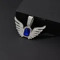 Detailed close-up of a silver angel wings pendant featuring a blue sapphire center stone - Pendant Only (No Chain) / Silver