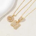 Gold plated initial M pendant necklaces with sparkling zircon crystals in round and cube style - M
