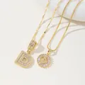 Detailed close-up of golden letter D pendants with shimmering zircon stones on chic chains - D Pendant And Necklace