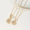 Close-up of two gold letter G necklaces with pavé zircon settings on rope and box chains - G Pendant And Necklace