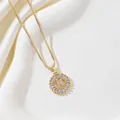 Macro shot of gold-plated letter K pendant with rectangular zircon and box chain - Letter K