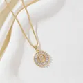 Gold letter P necklace with round cubic zirconia pendant on white silk background - Letter P