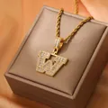 Macro detail of gold-plated letter W pendant with sparkling pavé zircons and rope chain - Letter W / Gold