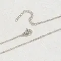 Close-up of silver necklace chain showing lobster clasp and extender details - O Chain / Silver