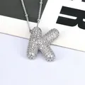 Close-up of silver letter K pendant necklace featuring pavé-set shimmering crystals - Letter K Style