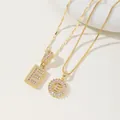 Golden letter E necklace set featuring pavé cubic zirconia on sunburst and square pendants - E Pendant And Necklace