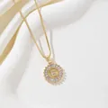 Gold-plated letter E round necklace with sparkling cubic zirconia on a silk background - Letter E