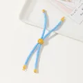 Detail of light blue braided cord bracelet featuring a gold tree of life charm bead - Lake Blue