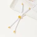 Close-up of white woven rope bracelet with gold adjustable slide buckle and floral engraving - White
