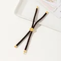 Detail of a dark brown braided cord bracelet with an engraved golden tree slide buckle - Dark Brown