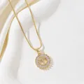 Elegant gold round pendant necklace featuring a sparkling cubic zirconia letter T design - Letter T