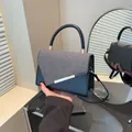 Elegant black and grey tweed patchwork handbag with gold metal clasp and top handle - Black