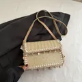 Beige straw crossbody bag featuring genuine shell embellishments and woven tassel edge - Khaki