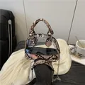 Elegante borsa in PVC trasparente con finiture nere in pelle di serpente e catena argento - Cachi