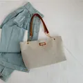 Borsa tote in nylon grigio chiaro con manici in pelle marrone e ciondolo a cervo dorato - Marrone