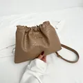 Chic brown woven bucket bag with drawstring closure and golden metal logo detail - Khaki