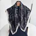 Detail of a black and white paisley cotton linen scarf hanging on a wooden hanger - Black White Paisley Wide Border Style (Style 22)