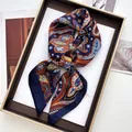 Close-up of luxury navy paisley silk scarf neatly folded in a premium gold gift box - 70cmx70cm / Navy Ethnic Paisley (45)