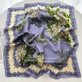 Elegant lavender silk square scarf featuring large peony floral prints on white table - Lavender